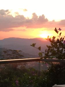a sunset from the top of a mountain at Skyloft Hostel in Kandy
