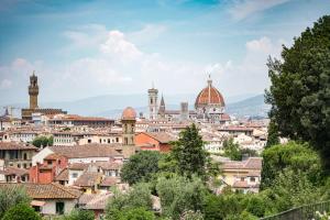 a view of a city with buildings and trees at Hotel Cerretani Firenze - MGallery Collection in Florence