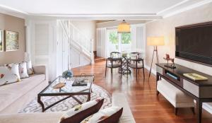 a living room with a couch and a tv at InterContinental Bali Resort by IHG in Jimbaran