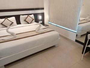 Voodi või voodid majutusasutuse Yuvraj Palace Inn toas
