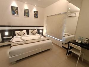 Voodi või voodid majutusasutuse Yuvraj Palace Inn toas
