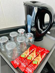 a counter with some food and cups and a coffee pot at EVO Soho Suites Duplex Homestay in Bandar Baru Bangi