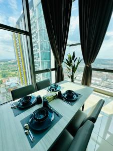 a table in a room with a view of a city at EVO Soho Suites Duplex Homestay in Bandar Baru Bangi