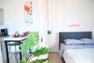 a bedroom with a bed and a desk and a table at Amazing seaview studio with pool-steps away beach in Áyios Yeórgios +19 photos