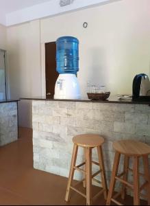 a kitchen with two stools and a blender on a counter at Tyner's Place in Panglao
