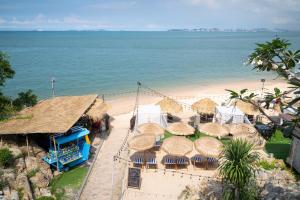 an aerial view of a beach with umbrellas and chairs at Mayaana Beach Resort Pattaya - Formerly Golden Tulip Pattaya Beach Resort in North Pattaya