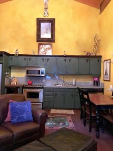 a kitchen with a couch and a table in a room at Snow Bear Breckenridge 4 in Taos Ski Valley