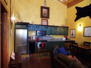 a kitchen with a refrigerator and a counter top at Snow Bear Breckenridge 4 in Taos Ski Valley