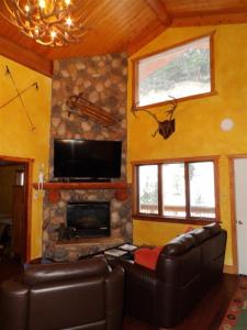 a living room with a couch and a fireplace at Snow Bear Breckenridge 4 in Taos Ski Valley