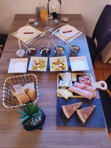 a wooden table with food on top of it at Õ 2040 Chambre Mélèze in Saint-Véran