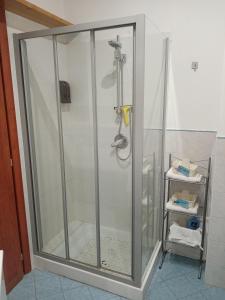 a shower with a glass door in a bathroom at Dante091 in Palermo +97 photos