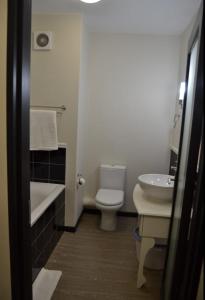 a bathroom with a white toilet and a sink at Cottonwoods Apartment for Family, Friends and Business trips. in Johannesburg
