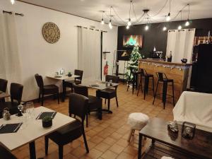 a restaurant with tables and chairs and a bar at Õ 2040 Chambre Sapin in Saint-Véran