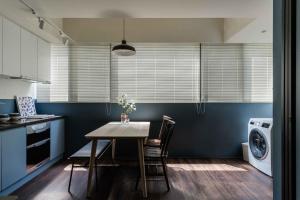 a kitchen with a table and a washing machine at Lin Apartments by Olala Homes in Taipei