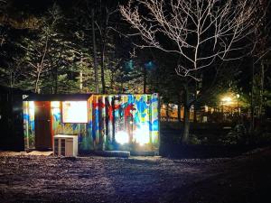 a building with a lit up facade at night at Pre Hub 十勝 