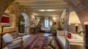 a large living room with a stone wall at Kókkini Porta Rossa in Rhodes Town