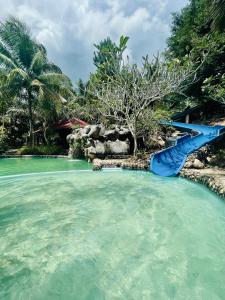 a blue slide in the water at a resort at Sahom Valley Resort - Agro & Eco Park in Kampar