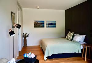a bedroom with a bed and a table in it at Pisa House Lakefront Boutique B&B in Cromwell