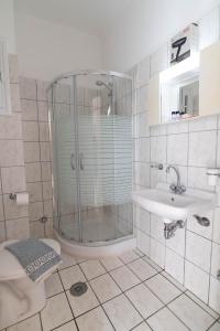 a bathroom with a shower and a sink and a toilet at Iraklis Hotel in Mytikas +64 photos
