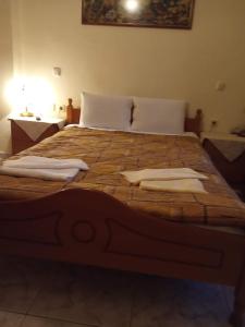 a large bed with two pillows on top of it at ΡΑΧΗ in Kerasea