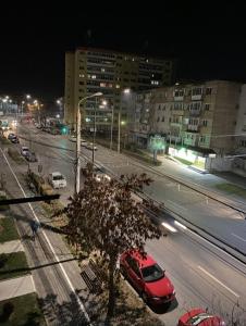 a red car parked on a city street at night at Studio 100G in Târgovişte