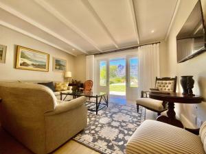 a living room with a couch and a table at Banhoek Corner Guesthouse in Stellenbosch