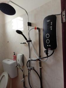 a shower in a bathroom with a blow dryer at 7Rooms Hotel Budget in Bandar  Pusat Jengka