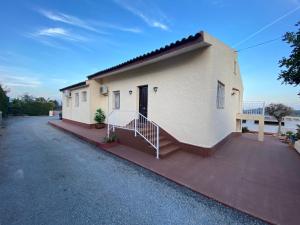 un bâtiment blanc avec un escalier à côté d'une allée. dans l'établissement Gran Villa La Marina, à Polop