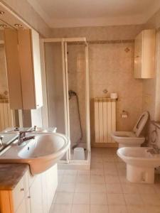 a bathroom with two sinks and a toilet and a shower at AMPAILLAN002 in Aosta
