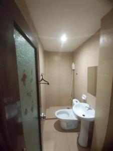 a bathroom with a toilet and a sink at OYO 924 Cosmo Hotel Espana Near Ust in Manila