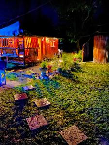 a garden with stepping stones in the grass at night at Balai Consuelo Pamingwitan Campground in Buliran