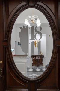 a mirror in a wooden door with the number on it at 1811 Residenza Storica in Naples