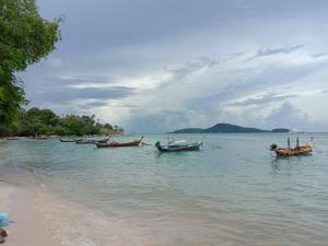 a group of boats in the water on a beach at Purimas Resortel in Rawai Beach