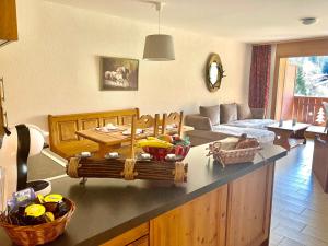 a kitchen with a counter with a fruit basket on it at Mountain River Appart in Val dʼIlliez