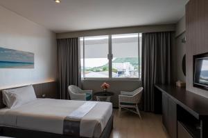 Postel nebo postele na pokoji v ubytování Pearl Hotel Phuket