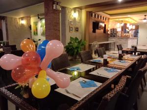 a bunch of balloons on a table in a restaurant at Purimas Resortel in Rawai Beach