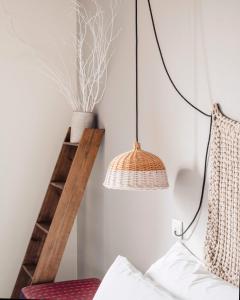a bedroom with a rattan lamp and a shelf at Can Alemany in Santa Margarita de Mombúy