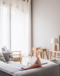 a living room with a couch and a large window at Can Alemany in Santa Margarita de Mombúy
