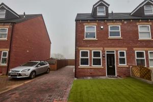 a car parked in front of a brick house at Homebird Property - Salisbury House in Leeds