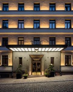 a front view of a hotel with a front door at Solo Sokos Hotel Torni Helsinki in Helsinki