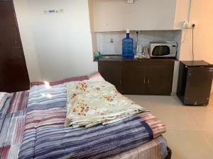 a bedroom with a bed with a pillow on it at Kamil’s Studio Apartment in Lucknow