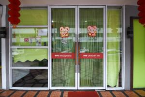 two glass doors with hello kitty signs on them at Super OYO 976 Dragon Inn in Miri