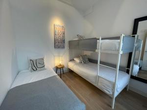 a bedroom with two bunk beds and a mirror at Residences Museum District in Amsterdam