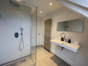 a bathroom with a sink and a shower at Residences Museum District in Amsterdam