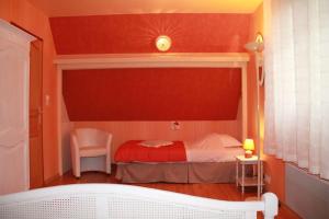 a small bedroom with a bed and a chair at Le Haut Mesnil-3 in Mesnil-Follemprise