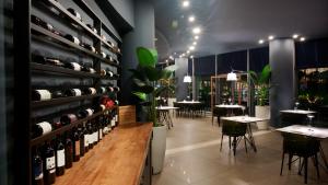 a restaurant with wine bottles on the wall and tables at voco Nola - Naples Vulcano Buono by IHG in Nola
