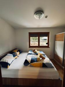 a bedroom with a bed with two teddy bears on it at Apartman Jahorina 6 in Jahorina