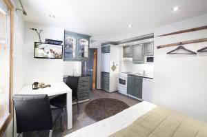 a kitchen with a desk and a table in a room at Vuokatin Aateli Studios in Vuokatti +12 photos