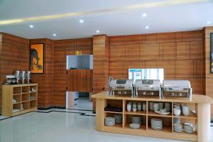 a kitchen with wooden walls and a counter with dishes at Khách sạn Xà Nu in Kon Tum