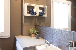 a bathroom with a sink and a mirror at Living4Malaga Centro Histórico y Playa in Málaga